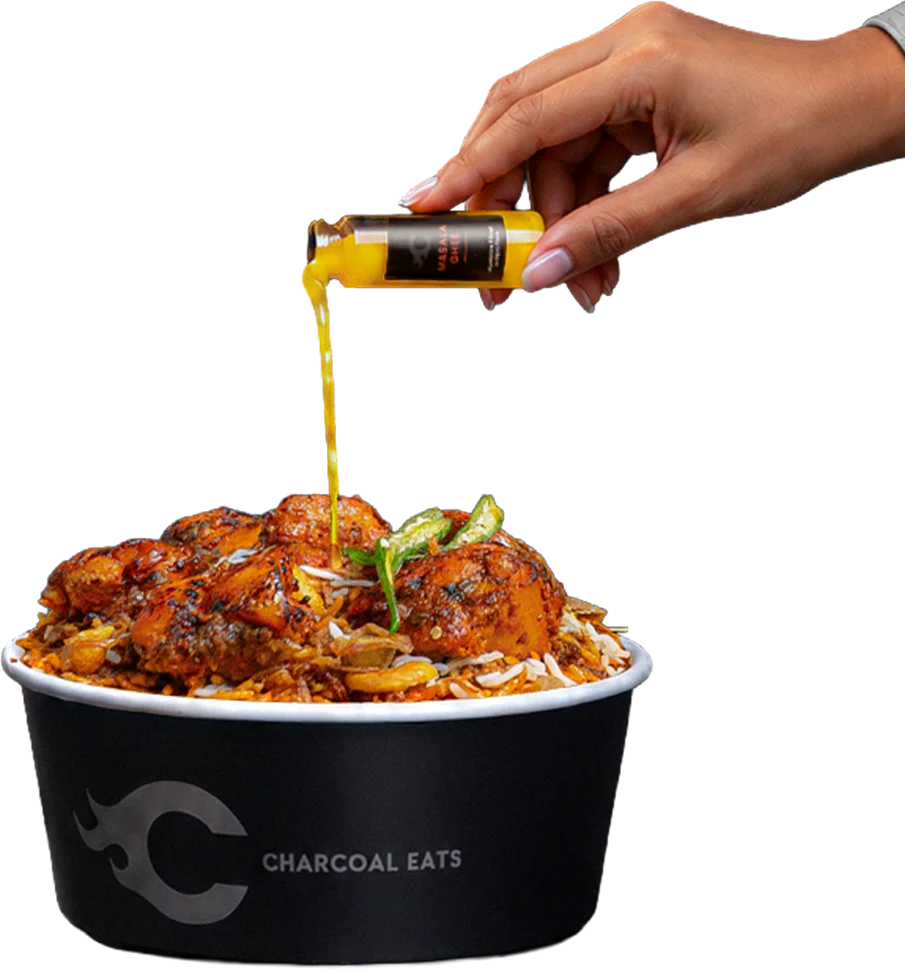 Pouring Masala Ghee over Charcoal Eats Black Biryani
